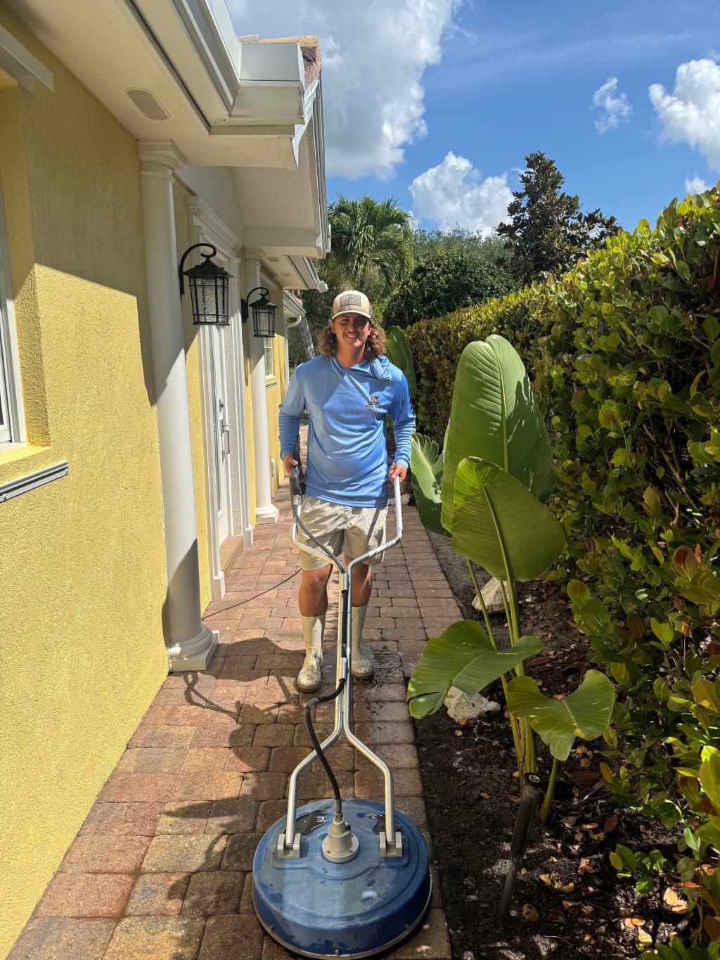 A photo of an Oasis expert soft washing pavers.